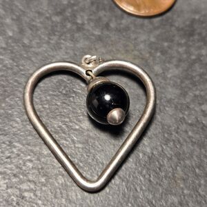 Sterling silver pendant with black dangle bead